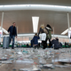 Passengers pull their suitcases through a floor littered with pieces of paper. Dec 1, 2016.